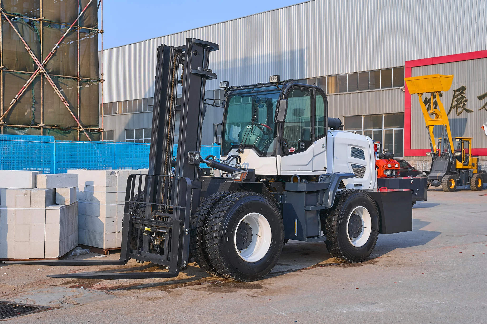T60 rough terrain forklift side view showing complete machine profile, load capacity demonstration, and industrial construction in warehouse setting